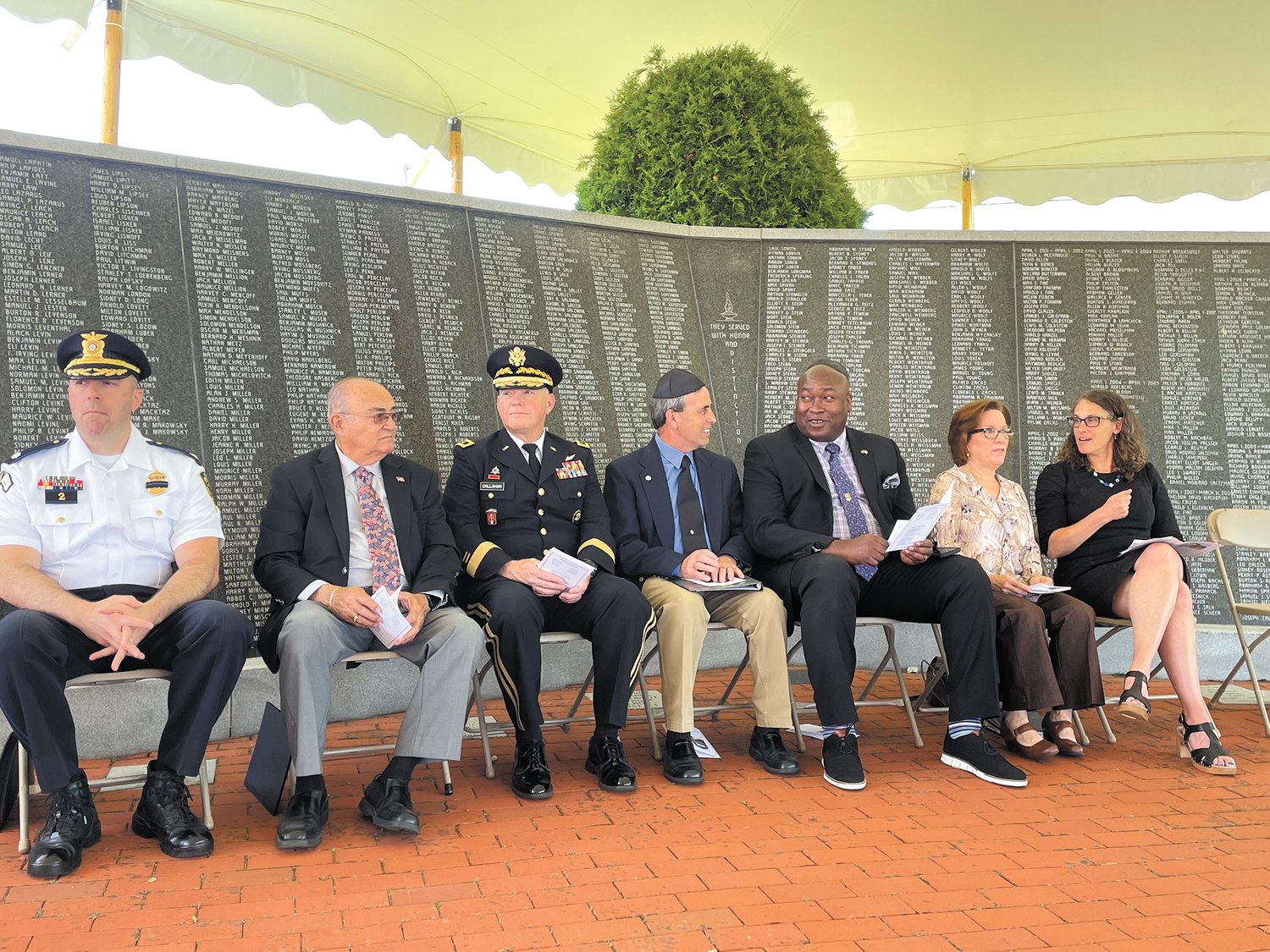 WHAT MEMORIAL DAY MEANS TO US: The speakers at the Jewish War Veterans Memorial Ceremony on Sunday, May 29 included the following: (left to right) Deputy Police Chief of Warwick Commander Mark Ullucci, Representative Samuel Azzinaro from the House Veterans Affairs Committee, Major General Christopher Callahan, Mayor of Warwick Frank Picozzi, Director of Veteran's Affairs for RI Kassim Yarn, Cantor Judy Seplowin and Rabbi Sarah Mack.